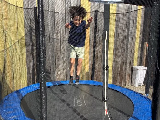 Child jumping on trampoline on Blue Bird Day Northcenter's roof deck play area
