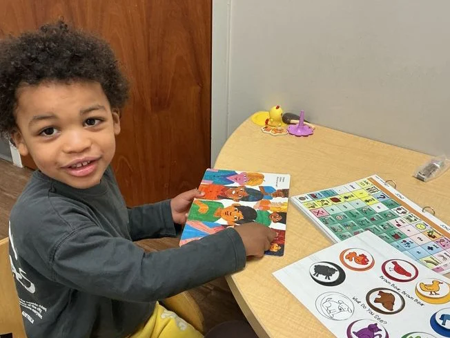 Child completing assessment activity at a table