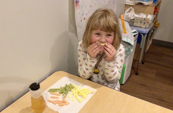 Child eating a crunchy snack at Blue Bird Day