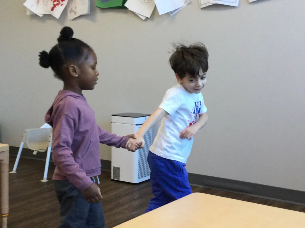 Children at Blue Bird Day holding hands